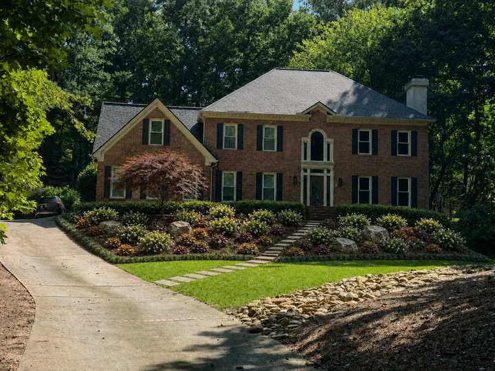 The same brick home with an AI-assisted landscaping concept